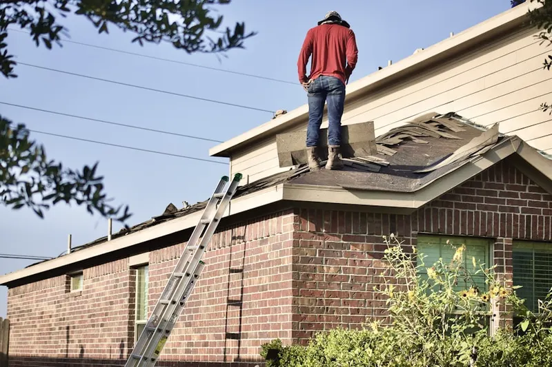 Professional roofer working on a residential roof in Gulf Coast Groves